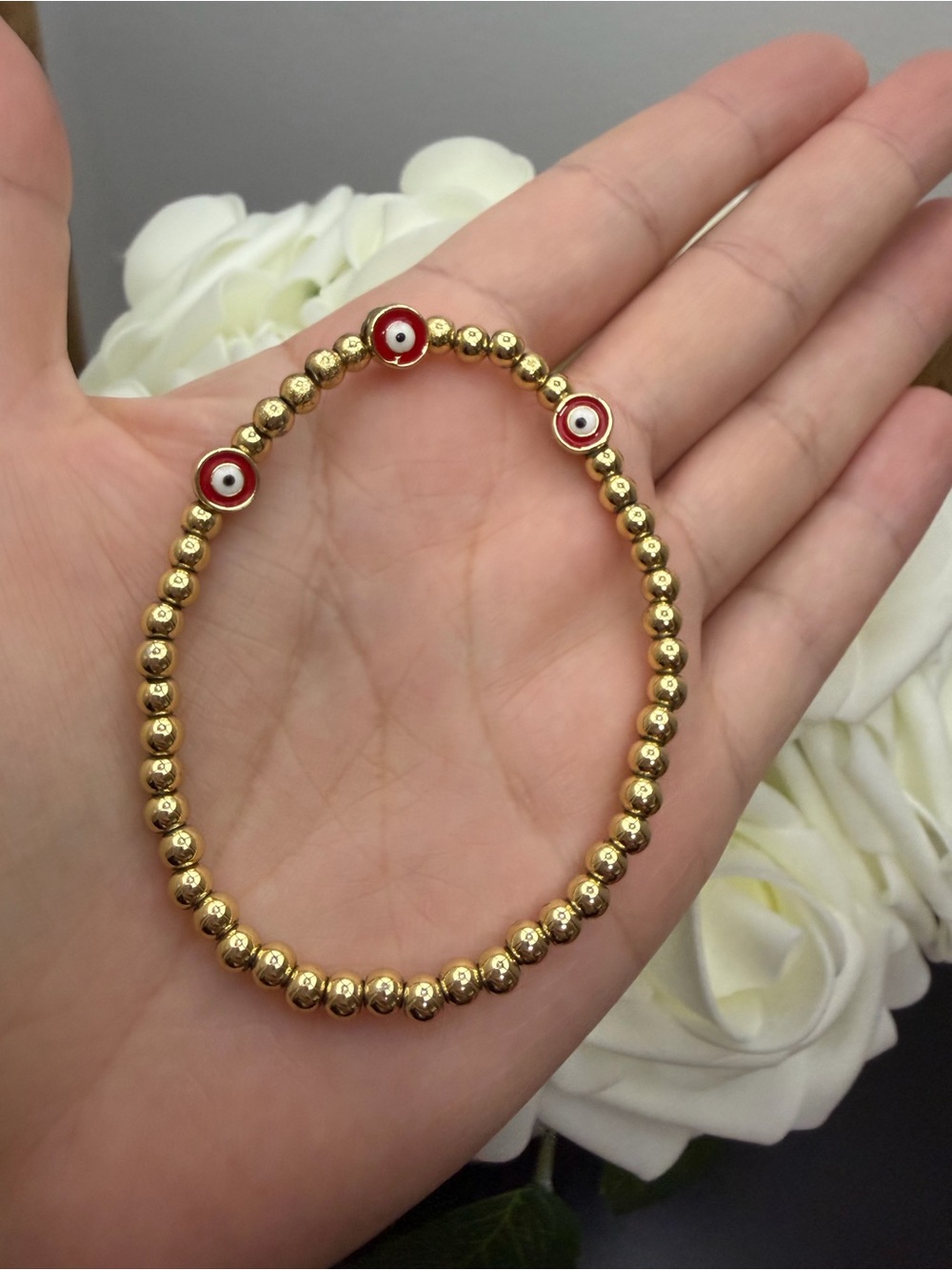 Gold filled Beaded Bracelet with Red Eye Charms